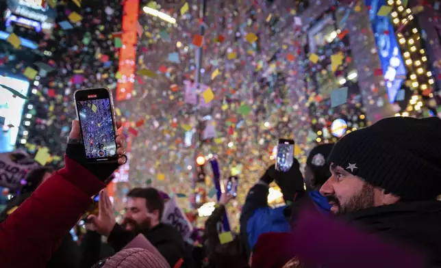 Revelers celebrate after the ball drops in New York's Times Square, Wednesday, Jan. 1, 2025, in New York. (AP Photo/Stefan Jeremiah)