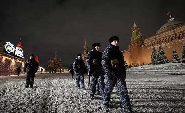 Police and the Rosguardia (National Guard) servicemen walk in Red Square, closed for celebrations on New Year's Eve in Moscow, Russia, Tuesday, Dec. 31, 2024. (AP Photo/Pavel Bednyakov)