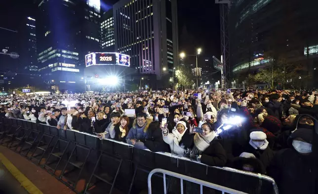 People gather during a countdown event at the Bosingak pavilion in Seoul, South Korea, Tuesday, Dec. 31, 2024. (Jean Shin/Newsis via AP)