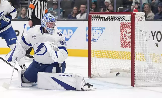 Tampa Bay Lightning goaltender Andrei Vasilevskiy (88) looks back as the puck goes into the net for a goal by San Jose Sharks center Tyler Toffoli during the first period of an NHL hockey game in San Jose, Calif., Thursday, Jan. 2, 2025. (AP Photo/Tony Avelar)