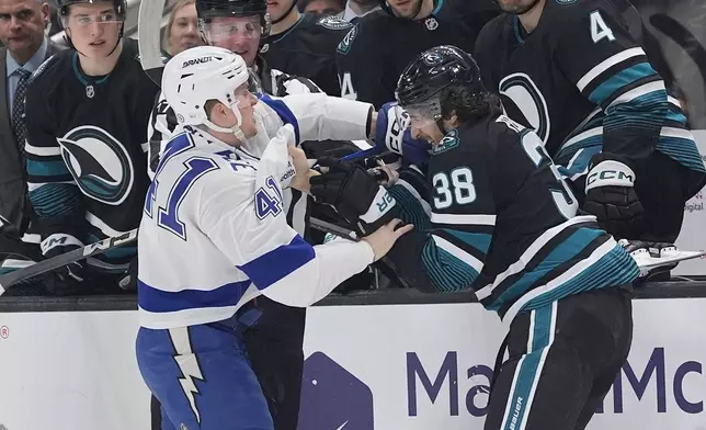 Tampa Bay Lightning right wing Mitchell Chaffee (41) fights with San Jose Sharks defenseman Mario Ferraro (38) during the second period of an NHL hockey game in San Jose, Calif., Thursday, Jan. 2, 2025. (AP Photo/Tony Avelar)