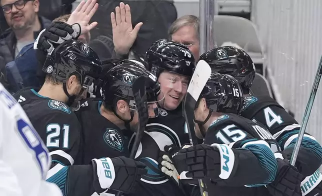 San Jose Sharks center Tyler Toffoli, center, celebrates with teammates after scoring a gaol against the Tampa Bay Lightning during the first period of an NHL hockey game in San Jose, Calif., Thursday, Jan. 2, 2025. (AP Photo/Tony Avelar)