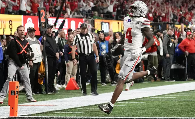 Ohio State wide receiver Jeremiah Smith runs for a touchdown against Notre Dame during first half of the College Football Playoff national championship game Monday, Jan. 20, 2025, in Atlanta. (AP Photo/Brynn Anderson)