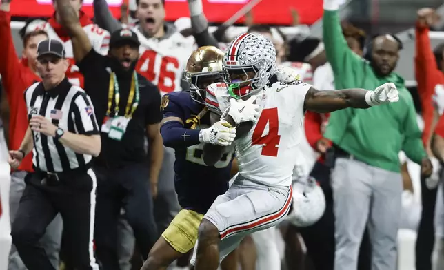 Ohio State wide receiver Jeremiah Smith catches a pass against Notre Dame during second half of the College Football Playoff national championship game Monday, Jan. 20, 2025, in Atlanta. (AP Photo/Butch Dill)