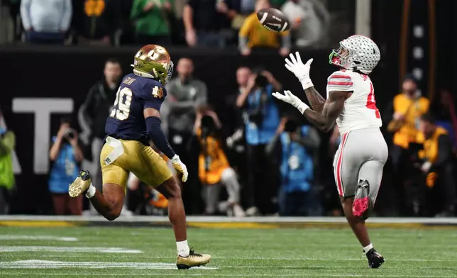 Ohio State wide receiver Jeremiah Smith catches a pass against Notre Dame during second half of the College Football Playoff national championship game Monday, Jan. 20, 2025, in Atlanta. (AP Photo/Jacob Kupferman)