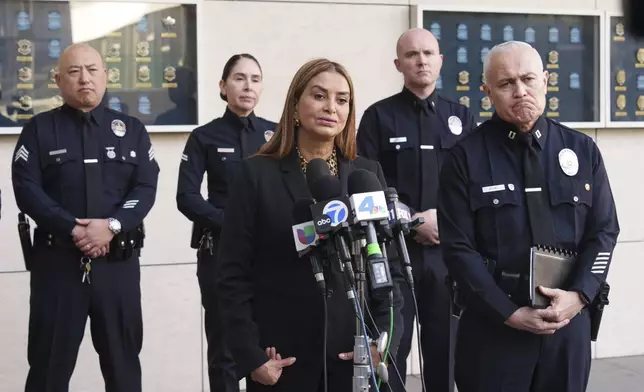 Los Angeles Police Cmdr. Lillian Carranza, front left, and Cpt. Raul Jovel give a press conference regarding a shooting at a Target store in Los Angeles Tuesday, Dec. 31, 2024. (AP Photo/Damian Dovarganes)