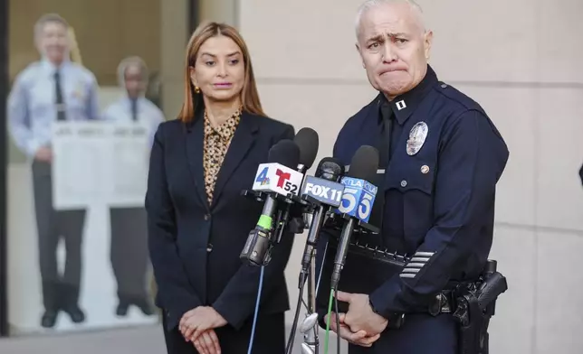 Los Angeles Police Cmdr. Lillian Carranza, front left, and Cpt. Raul Jovel give a press conference regarding a shooting at a Target store in Los Angeles Tuesday, Dec. 31, 2024. (AP Photo/Damian Dovarganes)