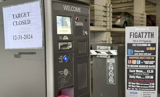 A closed sign is posted at a parking garage outside a Target store after two security guards were shot and wounded area after they confronted a man suspected of shoplifting in downtown Los Angeles on Tuesday, Dec. 31, 2024. (AP Photo/Damian Dovarganes)