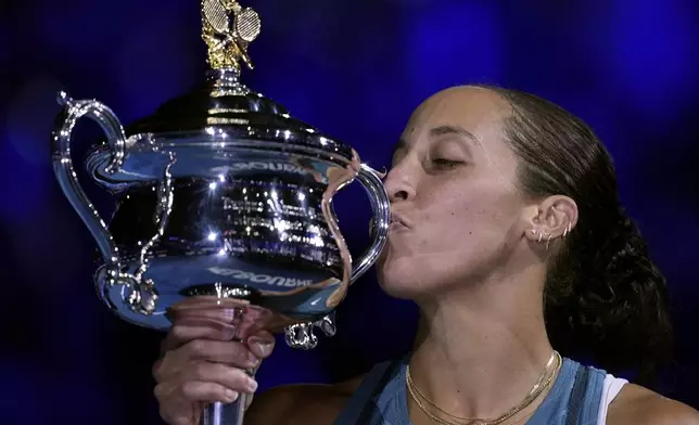 Madison Keys of the U.S. kisses the Daphne Akhurst Memorial Cup after defeating Aryna Sabalenka of Belarus in the women's singles final at the Australian Open tennis championship in Melbourne, Australia, Saturday, Jan. 25, 2025. (AP Photo/Ng Han Guan)