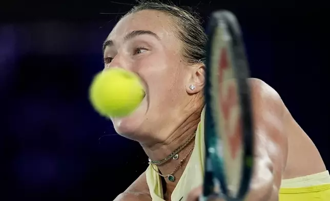 Aryna Sabalenka of Belarus plays a backhand return to Madison Keys of the U.S.during the women's singles final at the Australian Open tennis championship in Melbourne, Australia, Saturday, Jan. 25, 2025. (AP Photo/Asanka Brendon Ratnayake)