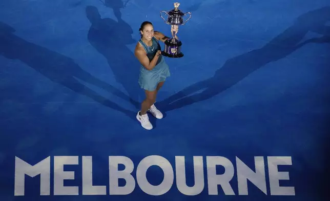 Madison Keys of the U.S. holds the Daphne Akhurst Memorial Cup aloft after defeating Aryna Sabalenka of Belarus in the women's singles final at the Australian Open tennis championship in Melbourne, Australia, Saturday, Jan. 25, 2025. (AP Photo/Manish Swarup)