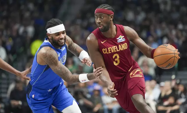 Cleveland Cavaliers guard Caris LeVert (3) drives against Dallas Mavericks guard Jaden Hardy during the first half of an NBA basketball game, Friday, Jan. 3, 2025, in Dallas. (AP Photo/Julio Cortez)