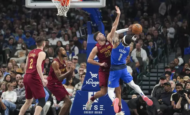 Dallas Mavericks guard Jaden Hardy (1) goes up for a basket against Cleveland Cavaliers forward Georges Niang during the first half of an NBA basketball game, Friday, Jan. 3, 2025, in Dallas. (AP Photo/Julio Cortez)