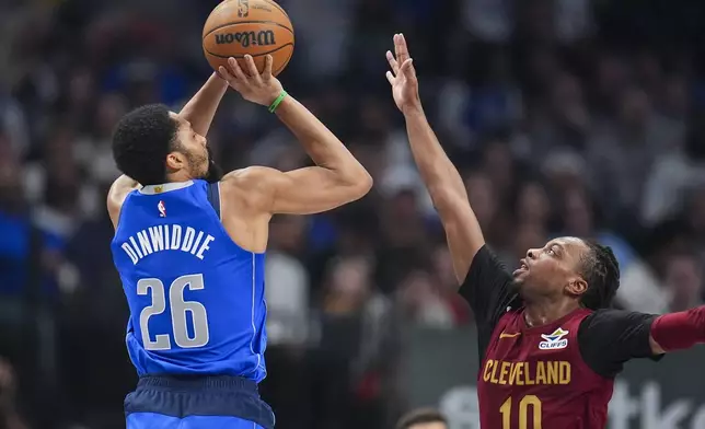 Dallas Mavericks guard Spencer Dinwiddie (26) shoots against Cleveland Cavaliers guard Darius Garland (10) during the first half of an NBA basketball game, Friday, Jan. 3, 2025, in Dallas. (AP Photo/Julio Cortez)