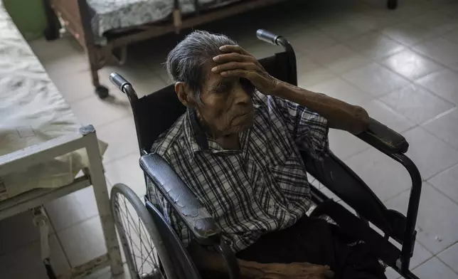 FILE - Raymundo Luna, 86, sleeps sitting in his wheelchair inside Cogra, a nursing home, amid a heat wave in the city of Veracruz, Mexico, on June 16, 2024. (AP Photo/Felix Marquez, File)