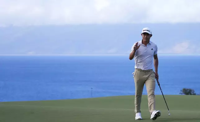 Collin Morikawa waves to the gallery after making a birdie putt at the 10th hole during the second round of The Sentry golf event, Friday, Jan. 3, 2025, at the Kapalua Plantation Course in Kapalua, Hawaii. (AP Photo/Matt York)