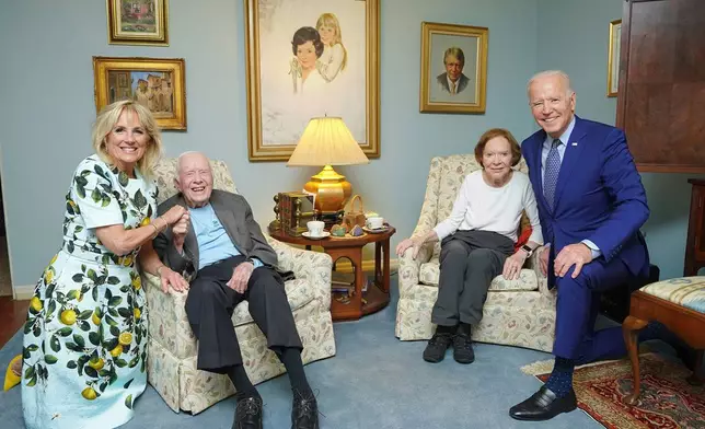 In this photo released by The White House, former President Jimmy Carter, center left, and former first lady Rosalynn Carter, center right, pose for a photo with President Joe Biden, right, and first lady Jill Biden at the home of the Carter's in Plains Ga., April 30, 2021. Former President Donald Trump is running against Biden, but Trump, the presumptive Republican nominee, keeps bringing up Carter. Trump likes to cite the 99-year-old former president as a measuring stick to belittle Biden. (Adam Schultz, The White House via AP)