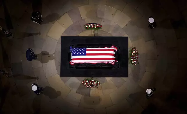 The flag-draped casket of former President Jimmy Carter lies in state at the rotunda of the U.S. Capitol Tuesday, Jan. 7, 2025, in Washington. (Andrew Harnik/Pool via AP)