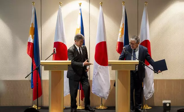 Japanese Foreign Minister Takeshi Iwaya, left, and Philippine Foreign Secretary Enrique Manalo prepare to leave following a joint press conference in Taguig City, Philippines Wednesday, Jan. 15, 2025. (Lisa Marie David/Pool Photo via AP)