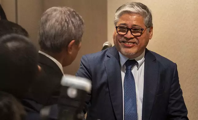 Philippine Foreign Secretary Enrique Manalo, right, reacts after a joint press conference with Japanese Foreign Minister Takeshi Iwaya in Taguig City, Philippines Wednesday, Jan. 15, 2025. (Lisa Marie David/Pool Photo via AP)