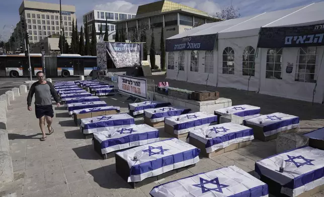 Symbolic coffins are displayed in Jerusalem to protest a hostage deal as Israel's security cabinet is set to convene to decide whether to approve a deal that would release dozens of hostages held by militants in Gaza and pause the 15-month-war, Friday, Jan. 17, 2025. (AP Photo/Mahmoud Illean)
