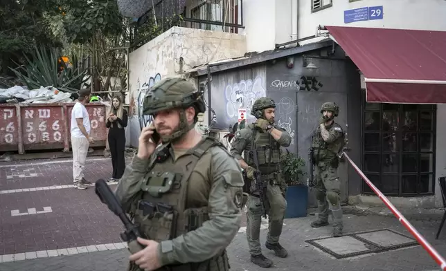 Israeli security forces secure the area of a stabbing attack in which several people were injured and the attacker was shot, in Tel Aviv, Israel, Saturday Jan. 18, 2025.(AP Photo/Oded Balilty)