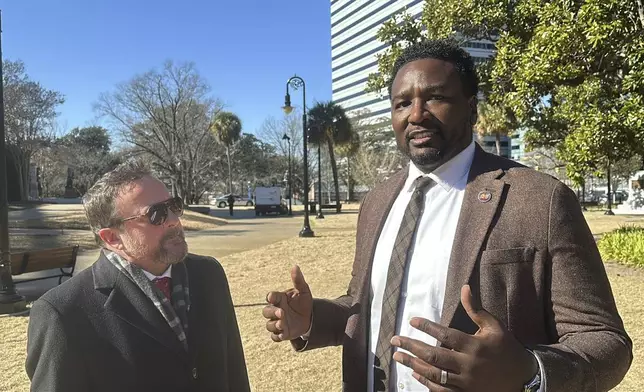 Republican South Carolina Rep. Brandon Cox from Goose Creek, left, and Democratic state Rep. Jermaine Johnson of Columbia, right, talk on the proposed site for a statue of Reconstruction hero Robert Smalls on Wednesday, Jan. 8, 2025, in Columbia, S.C. (AP Photo/Jeffrey Collins)