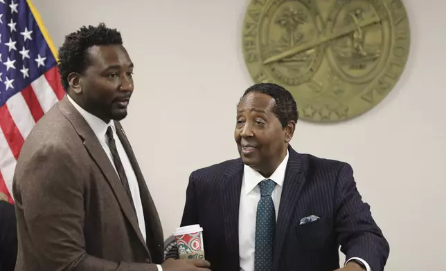 Democratic South Carolina Rep. Jermaine Johnson of Columbia, left, talks to Democratic state Sen. Darrell Jackson of Hopkins, right, before a meeting about a proposed statue of Reconstruction hero Robert Smalls on Wednesday, Jan. 8, 2025, in Columbia, S.C. (AP Photo/Jeffrey Collins)