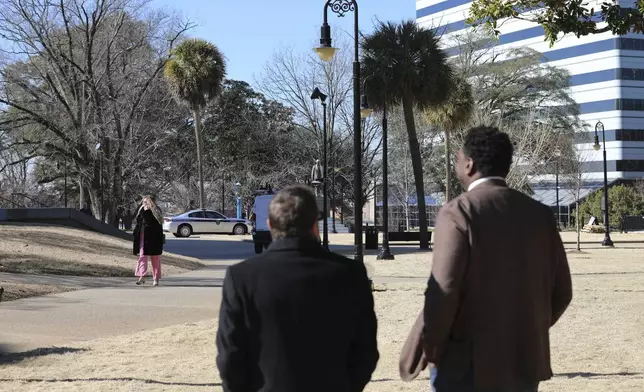 Republican South Carolina Rep. Brandon Cox from Goose Creek, left, and Democratic state Rep. Jermaine Johnson of Columbia, right, look across the Statehouse lawn at a statue of segregationist "Pitchfork" Ben Tillman from the proposed site for a statue of Reconstruction hero Robert Smalls on Wednesday, Jan. 8, 2025, in Columbia, S.C. (AP Photo/Jeffrey Collins)