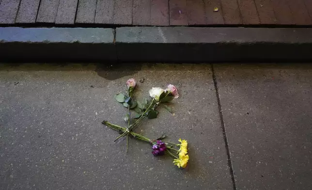 Flowers lie in the street at the site of a deadly truck attack on New Year's Day in New Orleans, Friday, Jan. 3, 2025. (AP Photo/Gerald Herbert)