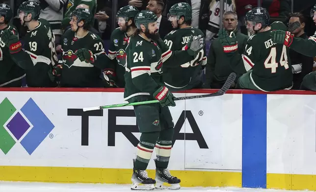 Minnesota Wild defenseman Zach Bogosian is congratulated for his goal during the first period of an NHL hockey game against the Colorado Avalanche, Thursday, Jan. 9, 2025, in St. Paul, Minn. (AP Photo/Matt Krohn)