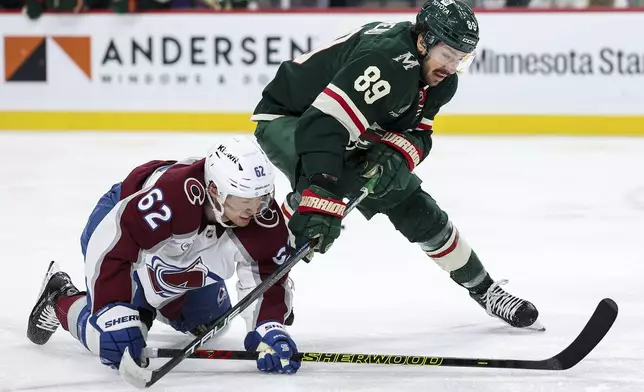 Minnesota Wild center Frederick Gaudreau, right, and Colorado Avalanche left wing Artturi Lehkonen, left, compete for the puck during the second period of an NHL hockey game Thursday, Jan. 9, 2025, in St. Paul, Minn. (AP Photo/Matt Krohn)