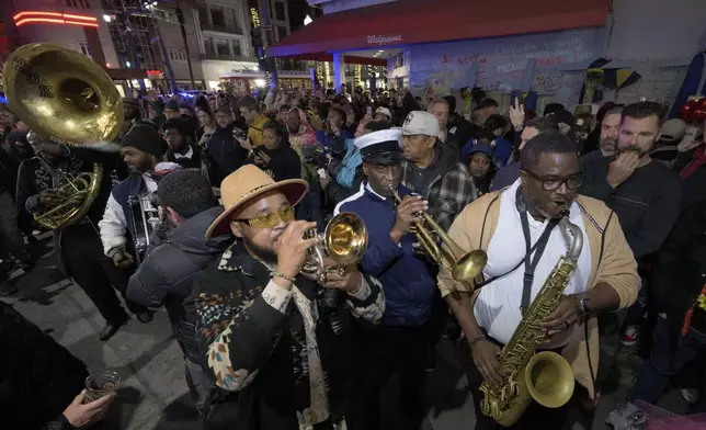 Amir "Tubad" Gray, front left, leads Tubad and the Kings of NOLA Brass Band in New Orleans, Saturday, Jan. 4, 2025, as they memorialize the victims of the New Year's Day deadly truck attack and shooting. Playing saxophone is Corey Hosey, trumpet is Kenneth Hagans, bass drum is Walter Kimble, and sousaphone is Timothy Brown. (AP Photo/Matthew Hinton)