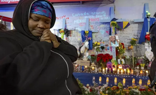 Courtney Polk, cousin of Tasha Polk, who was killed in the New Year's Day attack, reacts at a memorial on Bourbon Street and Canal Street in New Orleans, Saturday, Jan. 4, 2025, (AP Photo/Matthew Hinton)