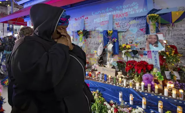 Courtney Polk, cousin of Tasha Polk, who was killed in the New Year's Day attack, reacts at a memorial on Bourbon Street and Canal Street in New Orleans, Saturday, Jan. 4, 2025, (AP Photo/Matthew Hinton)