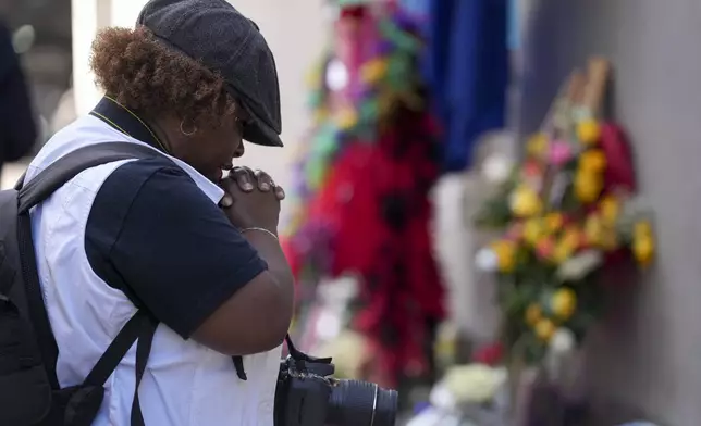 Shawn Westbrook prays at a memorial to the victims of a deadly truck attack on Bourbon Street in the French Quarter, Friday, Jan. 3, 2025, in New Orleans. (AP Photo/George Walker IV)