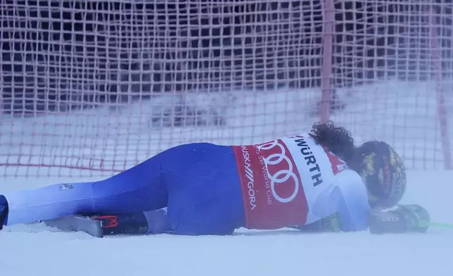 Italy's Federica Brignone lies on the snow after falling during an alpine ski, women's World Cup giant slalom race in Kranjska Gora, Slovenia, Saturday, Jan. 4, 2025. (AP Photo/Giovanni Auletta)