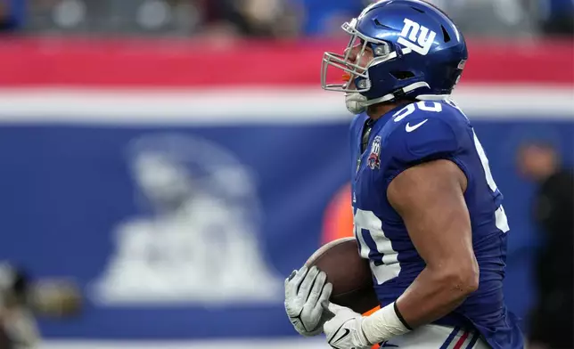 New York Giants defensive end Elijah Garcia (90) celebrates after recovering a fumble to stop the final drive by the Indianapolis Colts in the second half of an NFL football game Sunday, Dec. 29, 2024, in East Rutherford, N.J. (AP Photo/Seth Wenig)