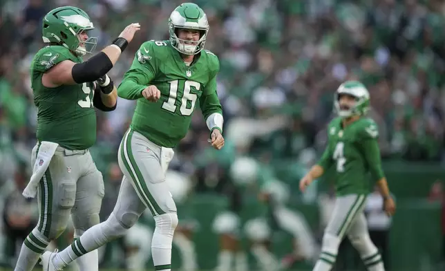 Philadelphia Eagles quarterback Tanner McKee (16) reacts after throwing a touchdown pass to wide receiver DeVonta Smith during the second half of an NFL football game against the Dallas Cowboys, Sunday, Dec. 29, 2024, in Philadelphia. (AP Photo/Matt Slocum)