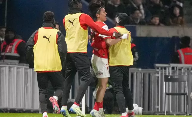 Reims' Keito Nakamura, celebrates with teammates after scoring his side's first goal during the French League One soccer match between Paris Saint-Germain and Reims at Parc des Princes stadium in Paris, Saturday, Jan. 25, 2025. (AP Photo/Michel Euler)