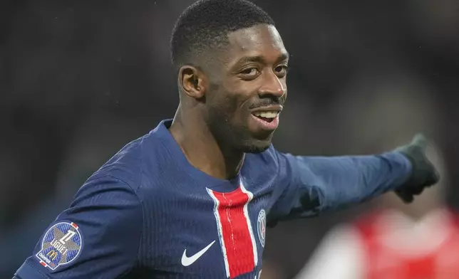 PSG's Ousmane Dembele celebrates after scoring the opening goal during the French League One soccer match between Paris Saint-Germain and Reims at Parc des Princes stadium in Paris, Saturday, Jan. 25, 2025. (AP Photo/Michel Euler)