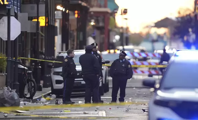 Emergency services attend the scene on Bourbon Street after a vehicle drove into a crowd on New Orleans' Canal and Bourbon Street, Wednesday Jan. 1, 2025. (AP Photo/Gerald Herbert)