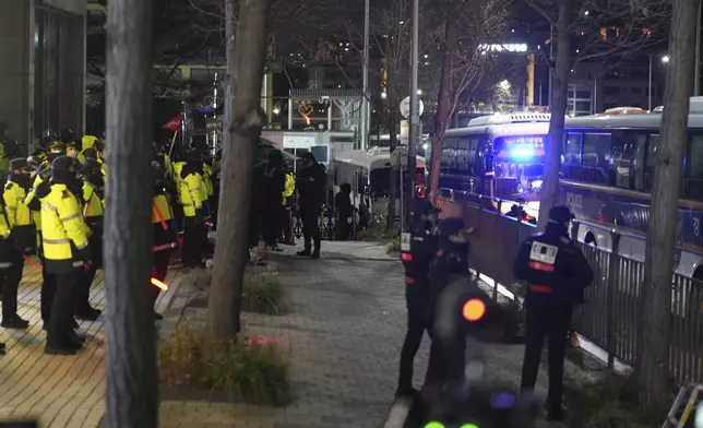 Police and barricades are placed in front of the gate of the presidential residence as supporters of impeached South Korean President Yoon Suk Yeol stage a rally to oppose a court having issued a warrant to detain Yoon, in Seoul, South Korea, Friday, Jan. 3, 2025. (AP Photo/Lee Jin-man)