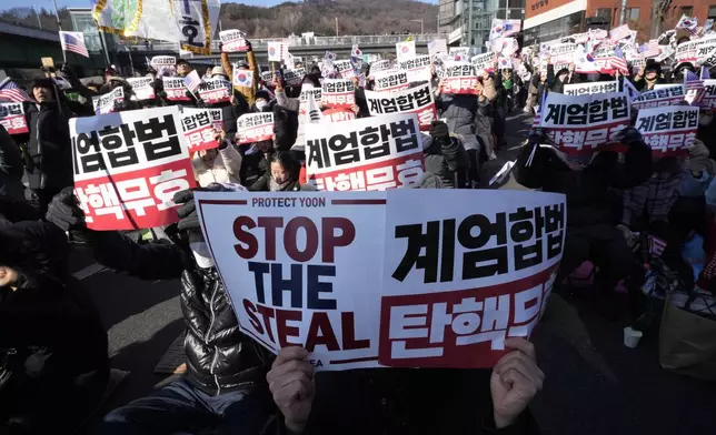 Supporters of impeached South Korean President Yoon Suk Yeol stage a rally to oppose a court having issued a warrant to detain Yoon, near the presidential residence in Seoul, South Korea, Thursday, Jan. 2, 2025. The signs read, "Oppose impeachment." (AP Photo/Ahn Young-joon)