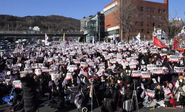 Supporters of impeached South Korean President Yoon Suk Yeol stage a rally to oppose a court having issued a warrant to detain Yoon, near the presidential residence in Seoul, South Korea, Thursday, Jan. 2, 2025. The signs read, "Oppose impeachment." (AP Photo/Ahn Young-joon)