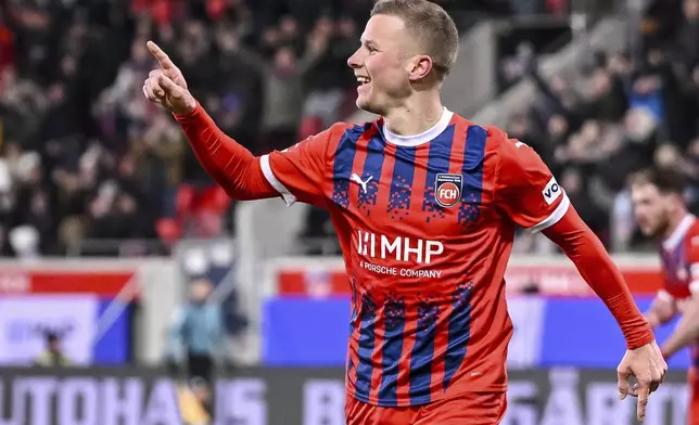 Heidenheim's Adrian Beck celebrates scoring during the Bundesliga soccer match between FC Heidenheim and FC Union Berlin at Voith-Arena, Heidenheim, Germany, Saturday Jan. 11, 2025. (Harry Langer/dpa via AP)