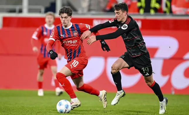 Heidenheim's Paul Wanner, left, and Berlin's Janik Haberer in action during the Bundesliga soccer match between FC Heidenheim and FC Union Berlin at Voith-Arena, Heidenheim, Germany, Saturday Jan. 11, 2025. (Harry Langer/dpa via AP)