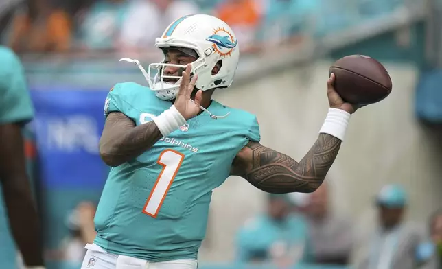 Miami Dolphins quarterback Tua Tagovailoa (1) warms up before an NFL football game against the San Francisco 49ers Sunday, Dec. 22, 2024, in Miami Gardens, Fla. (AP Photo/Rebecca Blackwell)