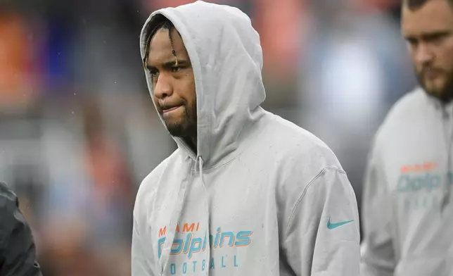 Miami Dolphins quarterback Tua Tagovailoa stands on the field before an NFL football game against the Cleveland Browns Sunday, Dec. 29, 2024, in Cleveland. (AP Photo/David Richard)