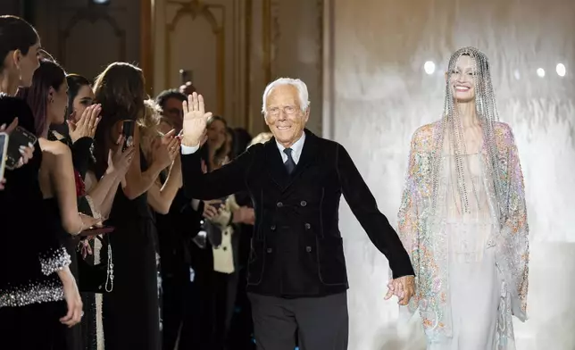 Giorgio Armani accepts applause at the end of the Giorgio Armani Prive Haute Couture Spring Summer 2025 collection, that was presented in Paris, Tuesday, Jan. 28, 2025. (AP Photo/Lewis Joly).